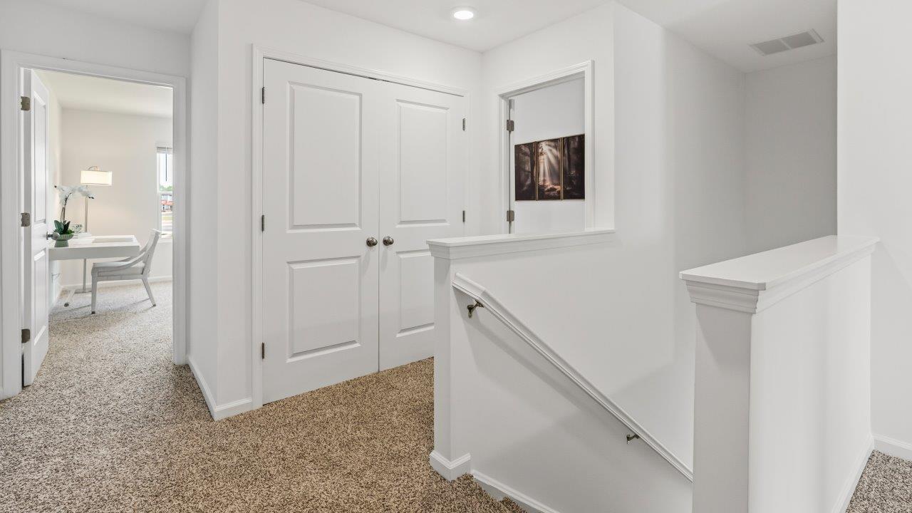Whispering Pines Pattison Model - second floor staircase landing with carpet flooring and white walls
