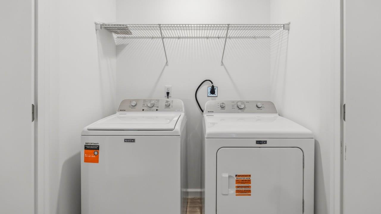 Whispering Pines Pattison Model - second floor laundry room with shelving, washer, and dryer