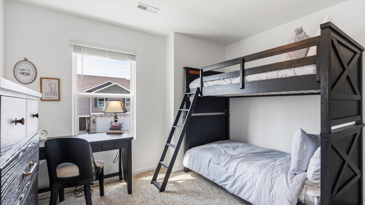 Whispering Pines Pattison Model - bedroom 3 with single window, beige carpet flooring, white walls, furnished as children's room with bunk beds