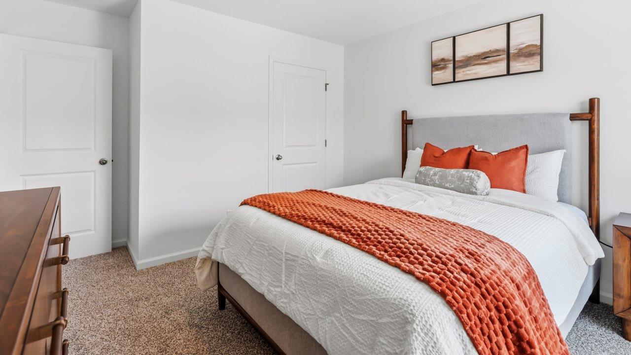 Whispering Pines Pattison Model - bedroom 4 with 1 single, beige carpet flooring, white walls, and ensuite closet furnished as bedrooom