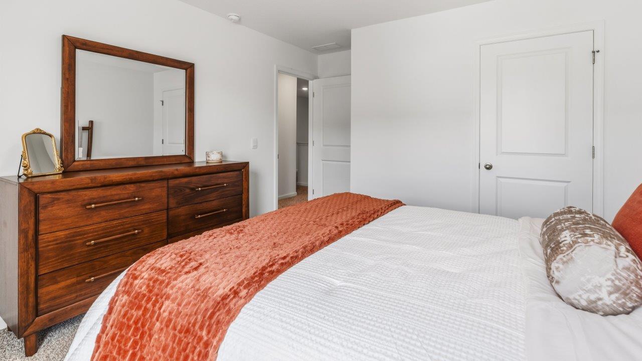 Whispering Pines Pattison Model - bedroom 4 with 1 single, beige carpet flooring, white walls, and ensuite closet furnished as bedrooom