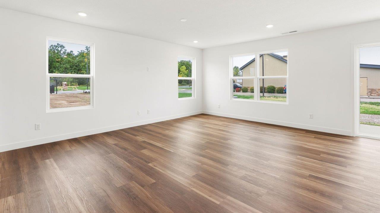 whispering pines portsmouth - open layout living room with mohawk lvp flooring and natural lighting with many windows