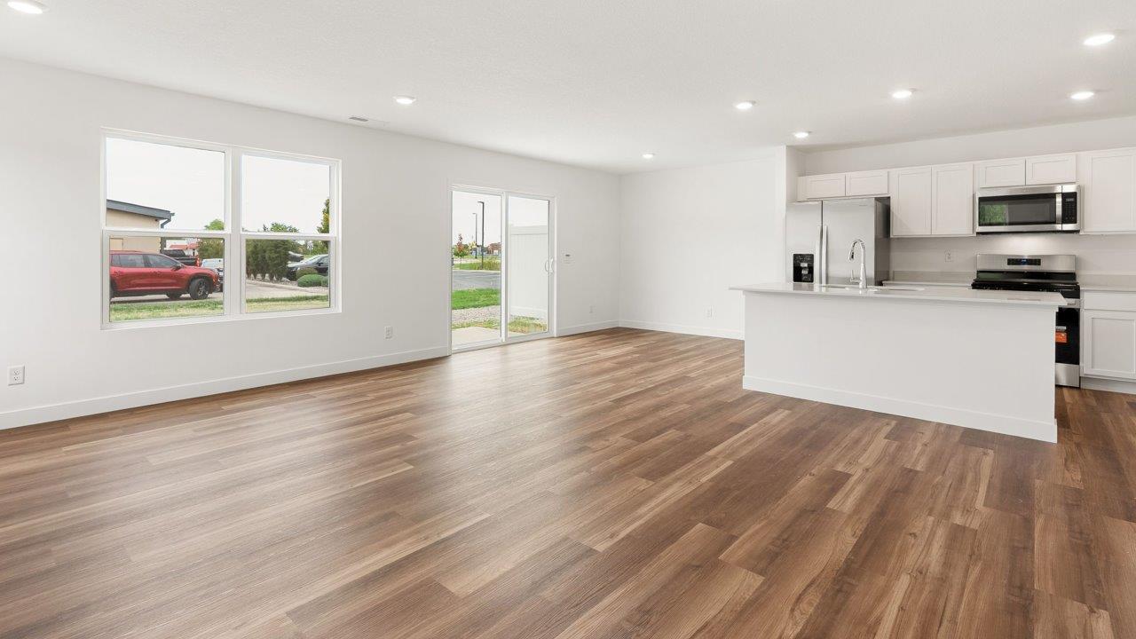 whispering pines portsmouth - open layout living room with mohawk lvp flooring and natural lighting with many windows