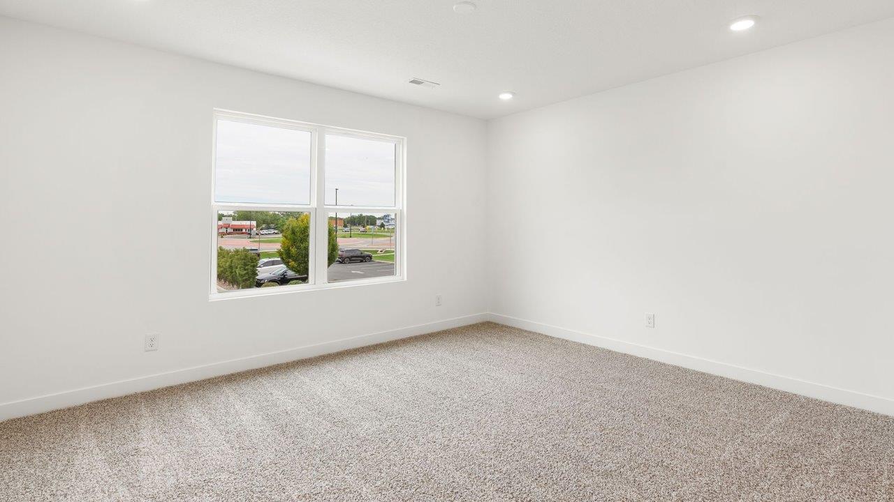 whispering pines portsmouth - primary bedroom with elk beige carpet flooring, 2 windows, white walls, and ensuite bathroom and walk in closet