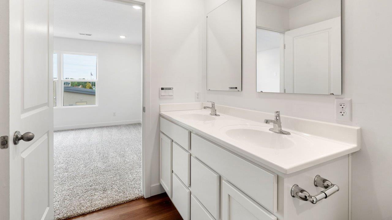 whispering pines portsmouth - primary bedroom ensuite bathroom with dual sink vanity and walk in shower