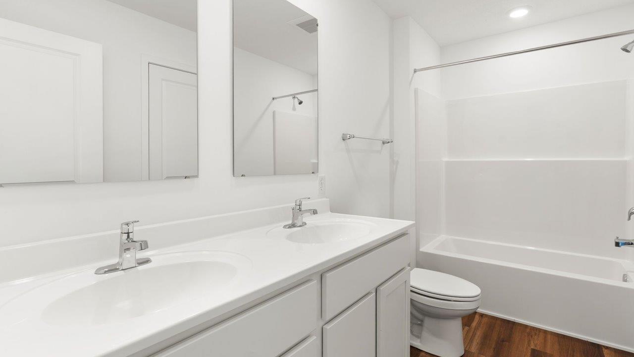 whispering pines portsmouth - full bathroom with dual sink vanity and tub shower