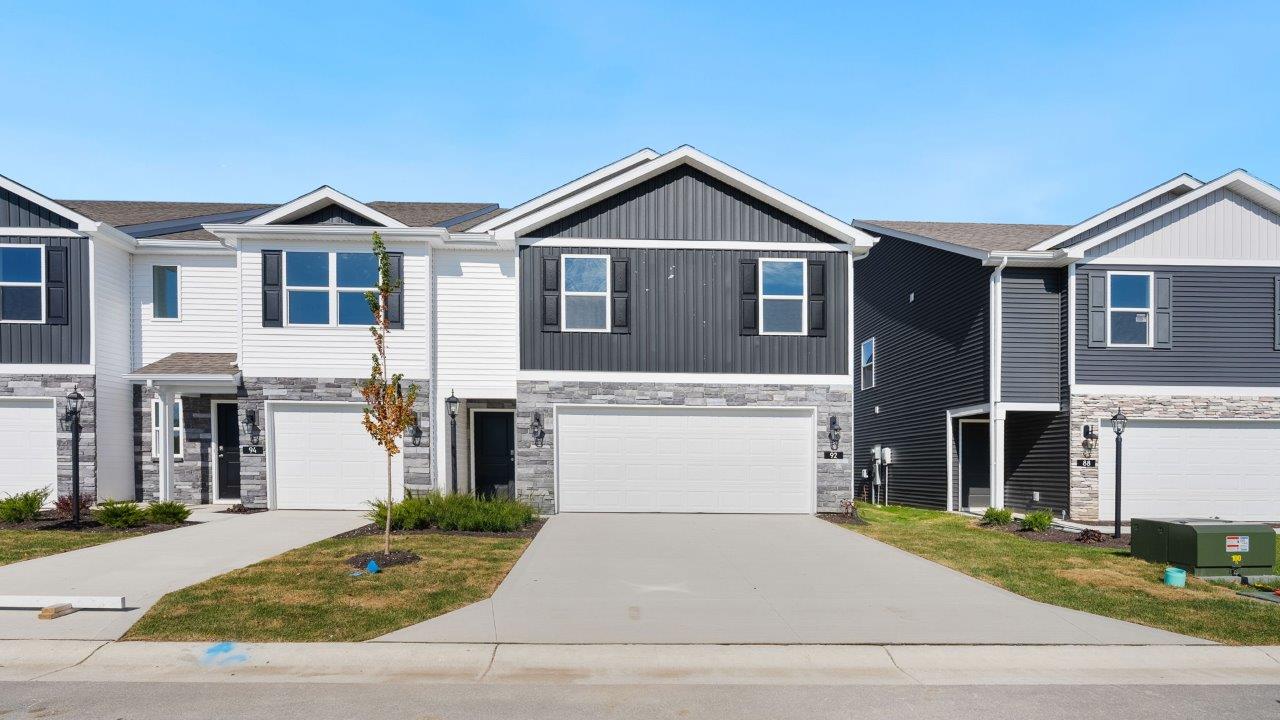 Whispering Pines portsmouth exterior with 2 car garage, covered front door, sodded yard