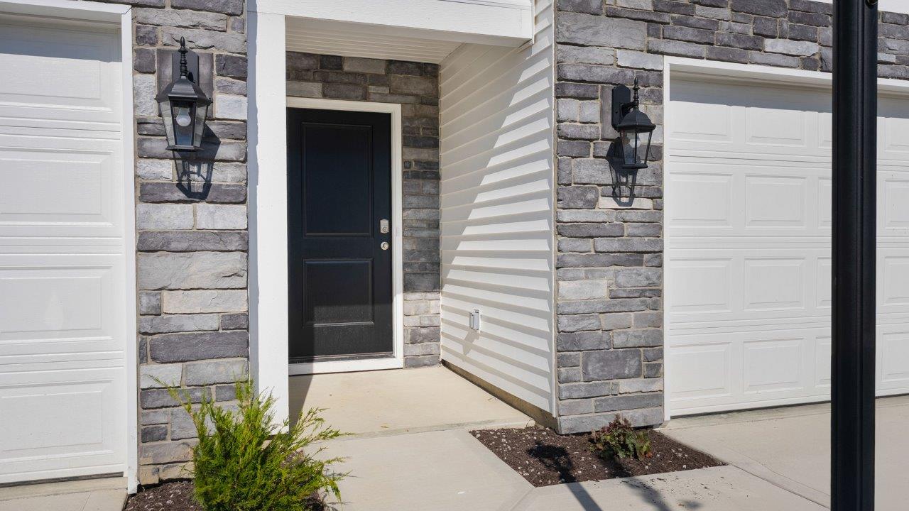 Whispering Pines portsmouth exterior with 2 car garage, covered front door, sodded yard