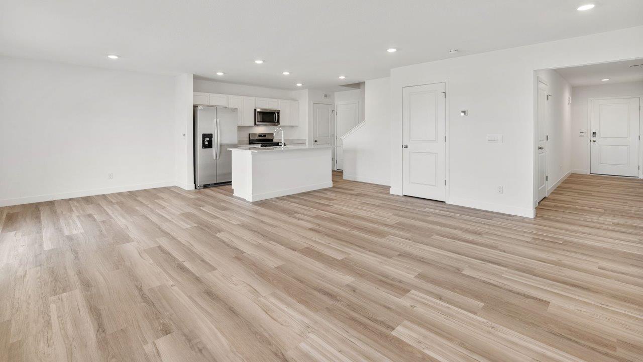 whispering pines portsmouth interior open layout living room with white walls, disc lighting, light mohawk lvp flooring