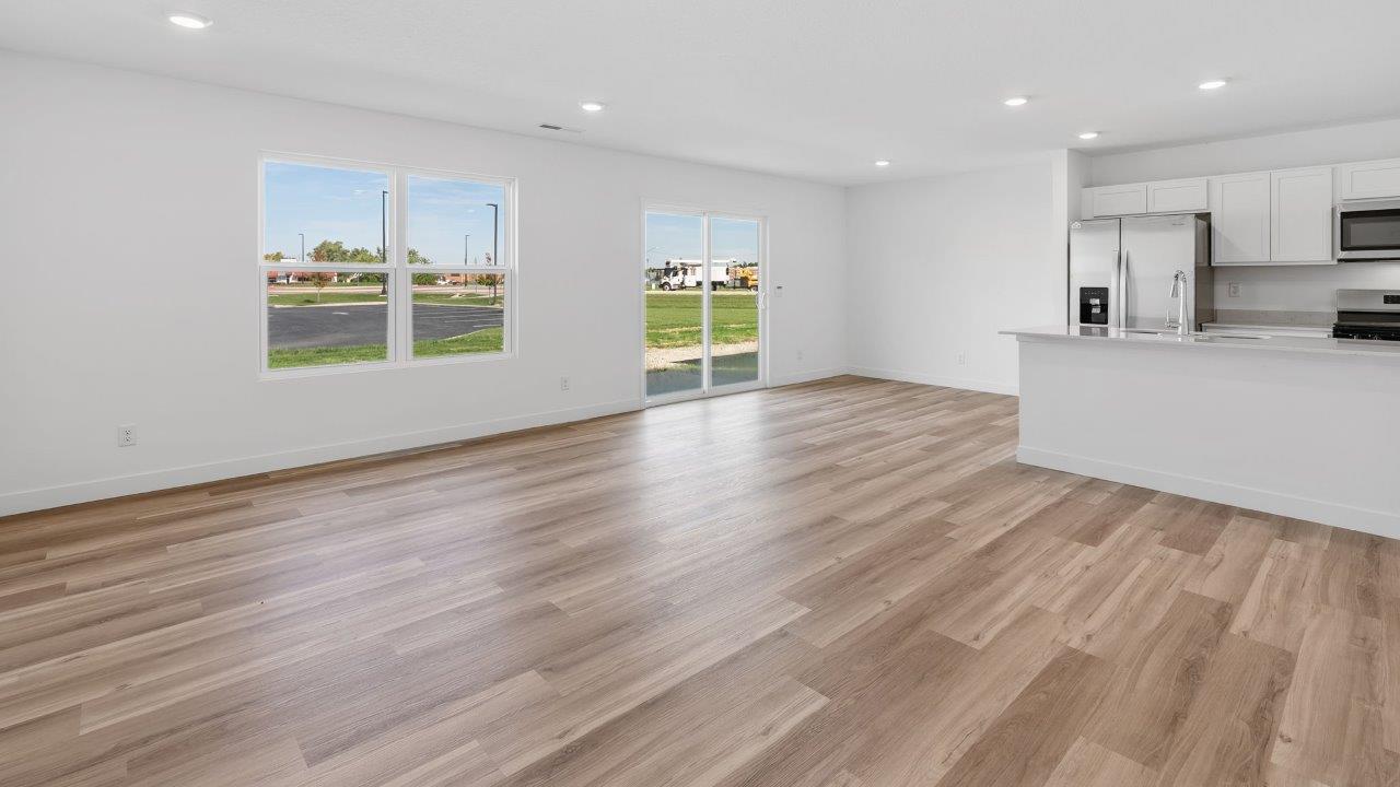 whispering pines portsmouth interior open layout living room with white walls, disc lighting, light mohawk lvp flooring
