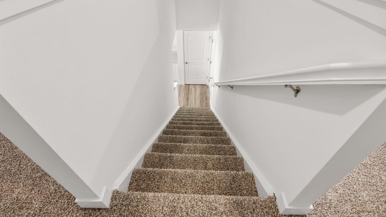 whispering pines portsmouth staircase with beige carpet flooring