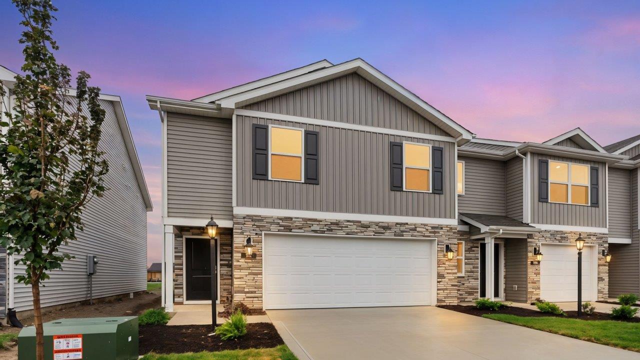 whispering pines portsmouth exterior with harvard slate board and batton, rustic ledge peeble beach stone, and harvard slate vinyl siding