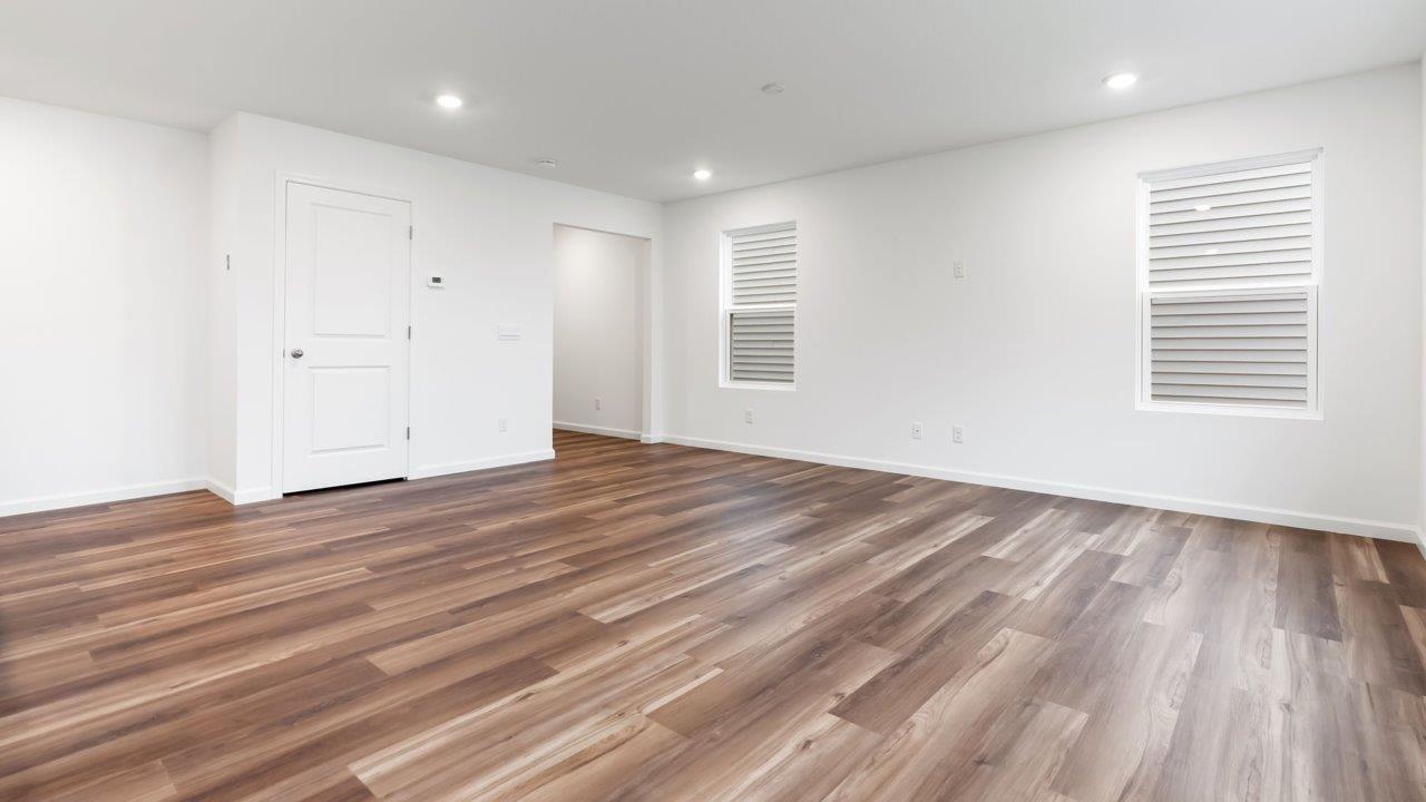 whispering pines portsmouth open layout living room with mohawk lvp flooring and natural lighting