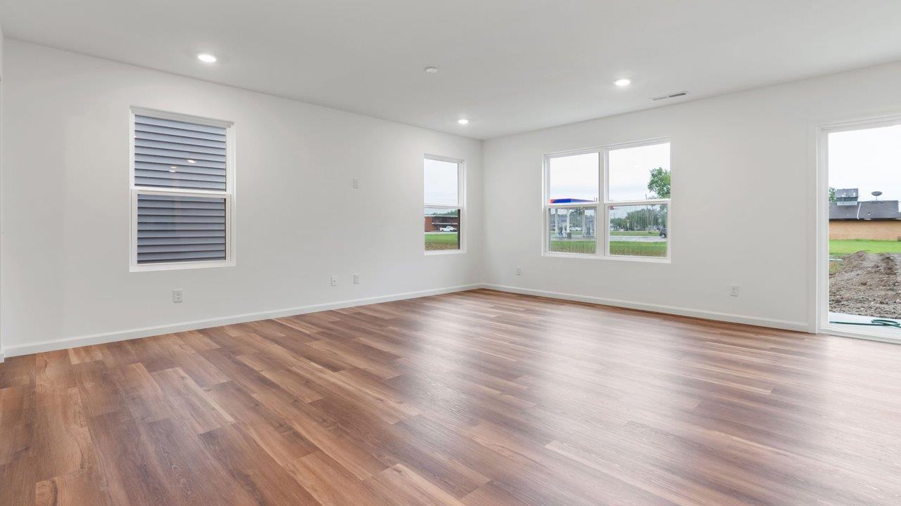 whispering pines portsmouth open layout living room with mohawk lvp flooring and natural lighting