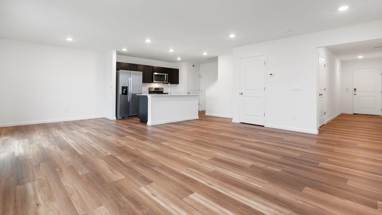 whispering pines portsmouth open layout living room with mohawk lvp flooring and natural lighting
