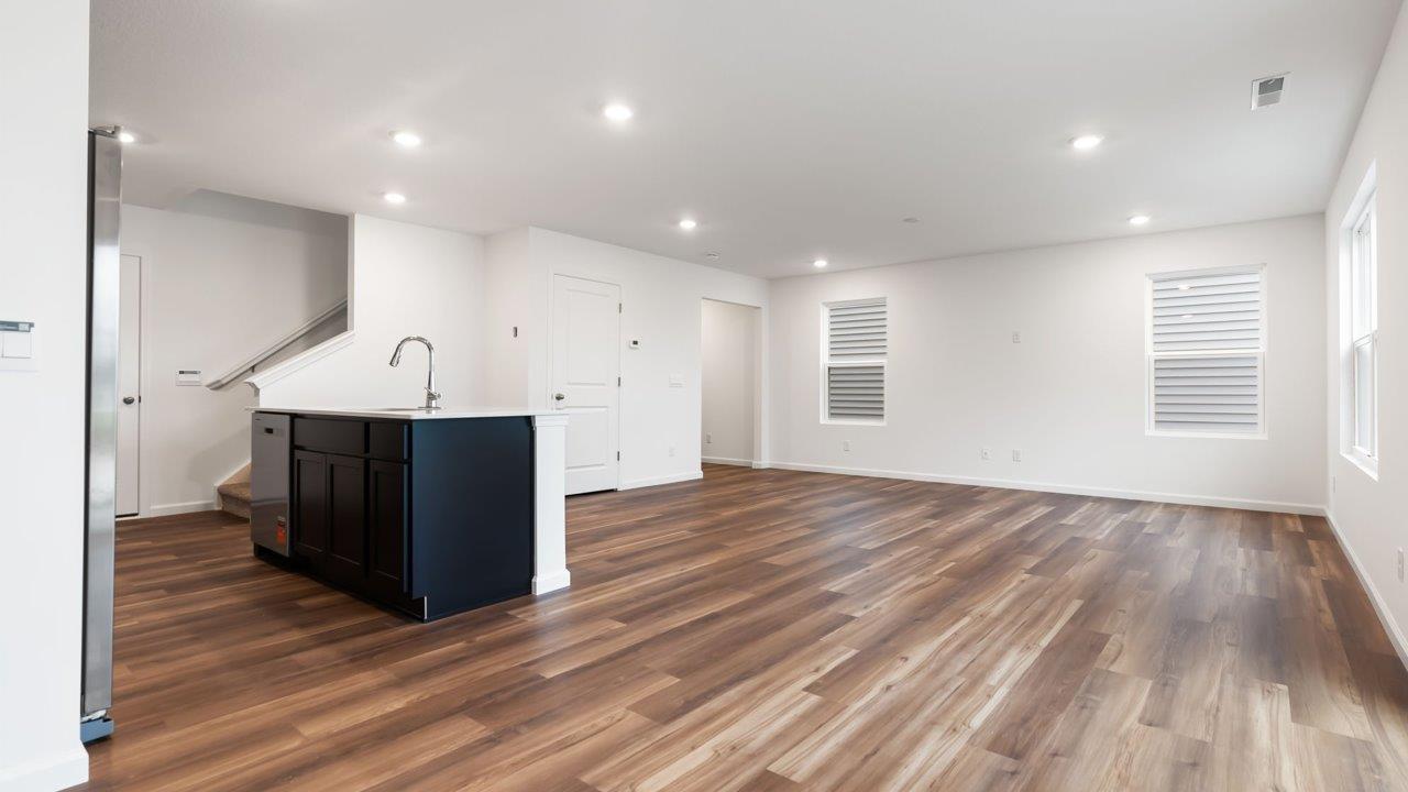 whispering pines portsmouth open layout living room with mohawk lvp flooring and natural lighting