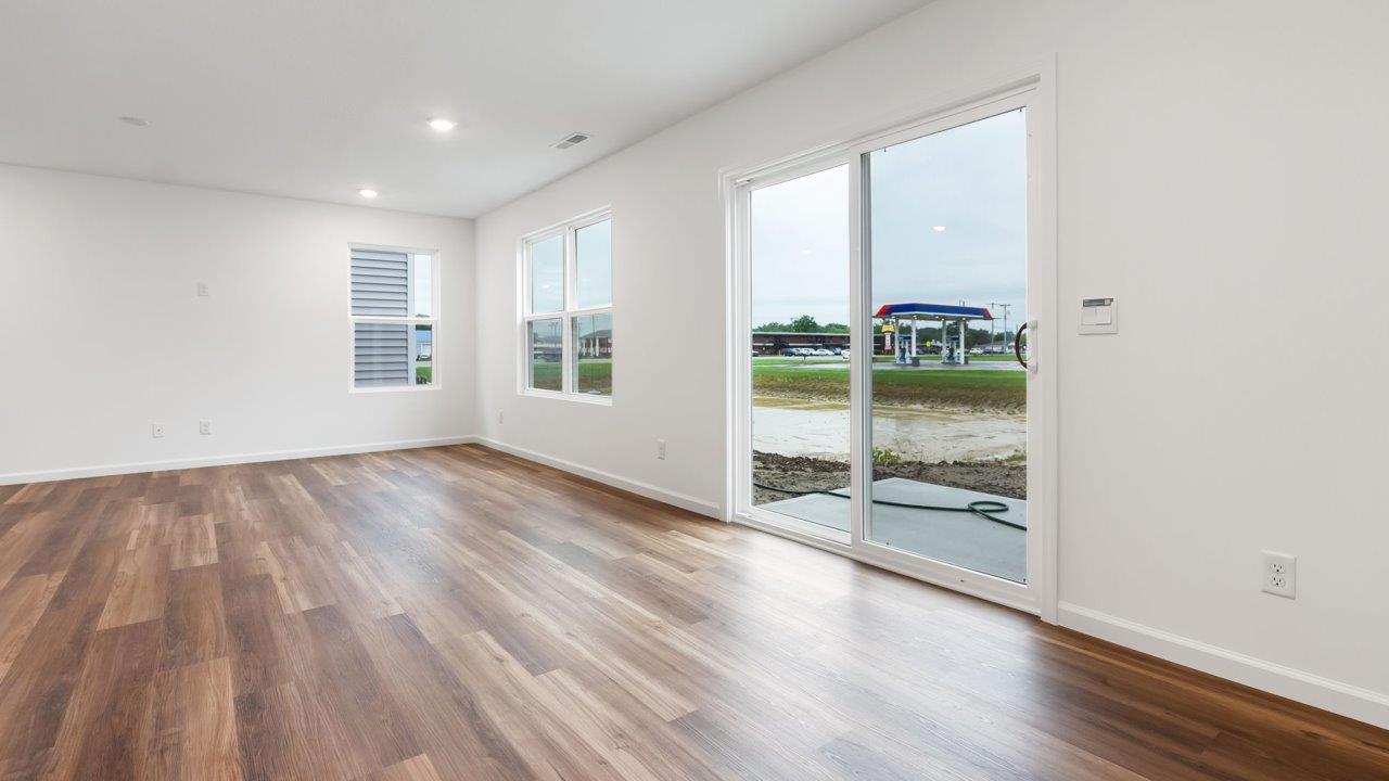 whispering pines portsmouth casual dining space with lvp flooring and sliding glass door to backyard