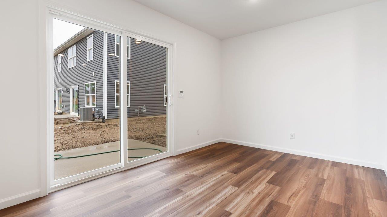 whispering pines portsmouth casual dining space with lvp flooring and sliding glass door to backyard