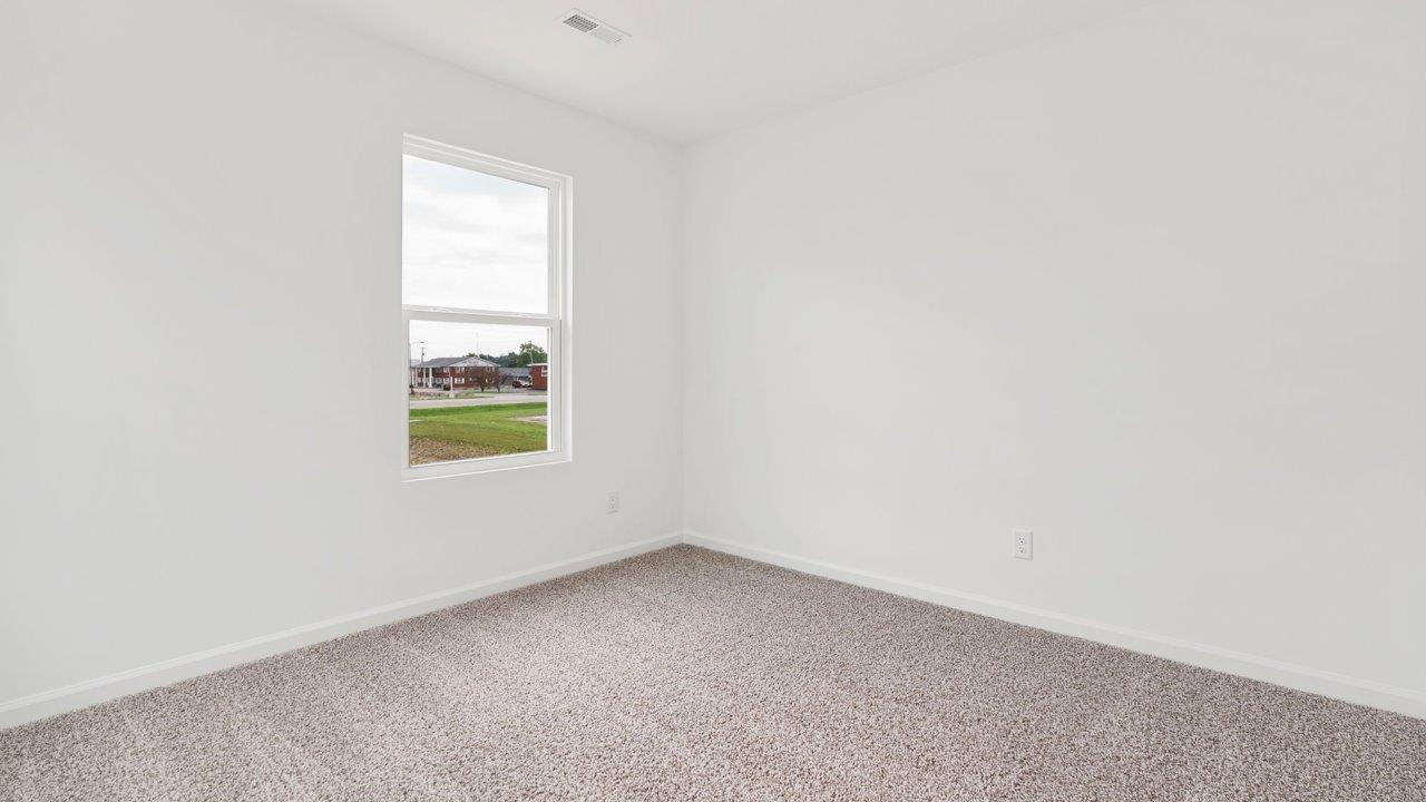 bedroom 4 with carpet flooring, 1 window, white walls, and ensuite closet