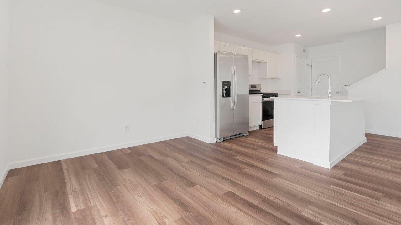 casual dining room with mohawk luxury vinyl plank flooring and sliding glass door to backyard
