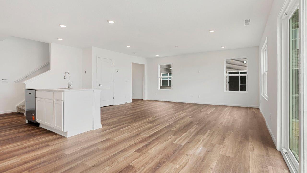 casual dining room with mohawk luxury vinyl plank flooring and sliding glass door to backyard