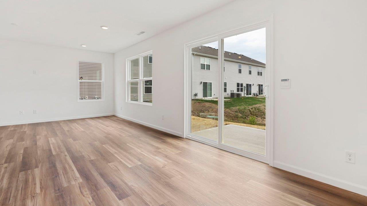 casual dining room with mohawk luxury vinyl plank flooring and sliding glass door to backyard