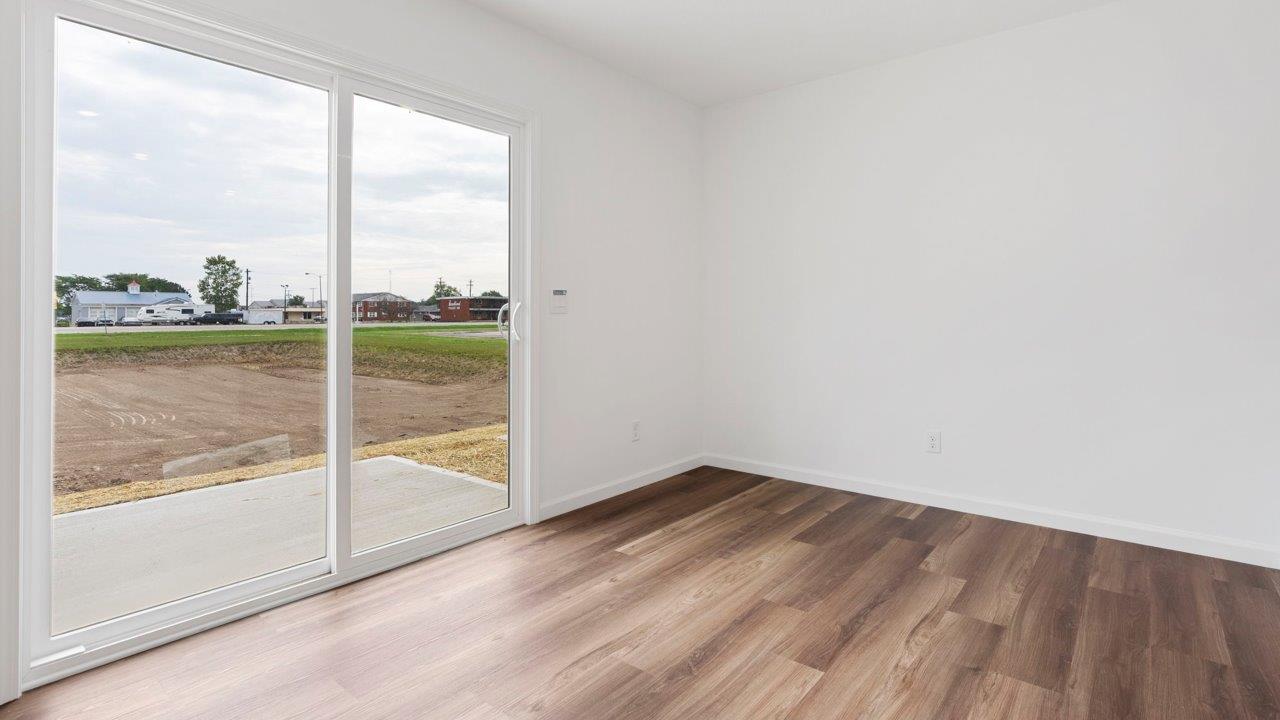 casual dining room with mohawk luxury vinyl plank flooring and sliding glass door to backyard
