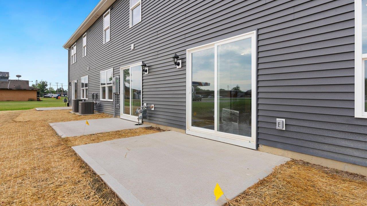 rear exterior with concrete patio