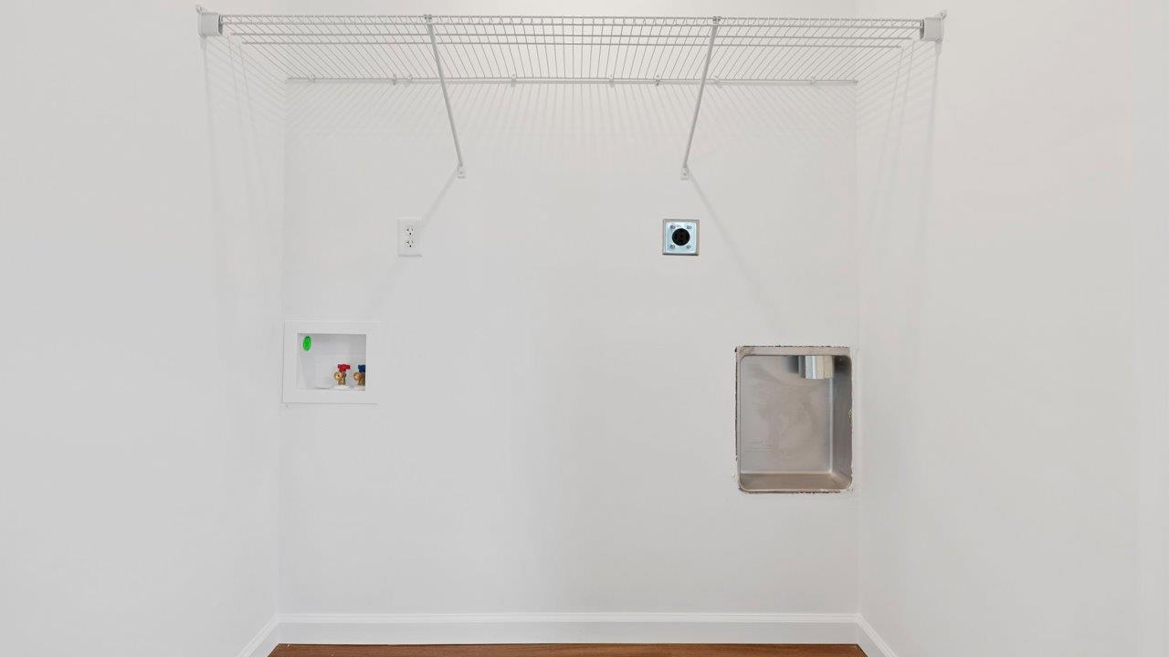 laundry room with lvp flooring and ventilated shelf built in