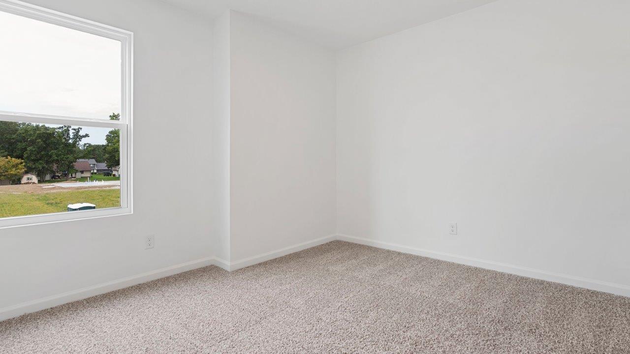 bedroom 2 with carpet flooring, 1 window, white walls, and ensuite closet