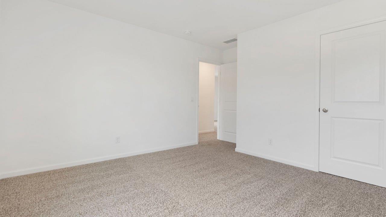 bedroom 3 with carpet flooring, 1 window, white walls, and ensuite closet