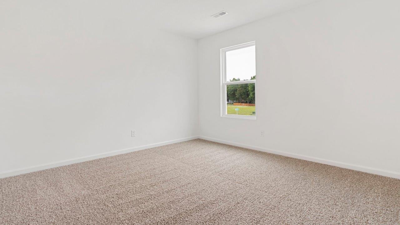 bedroom 3 with carpet flooring, 1 window, white walls, and ensuite closet