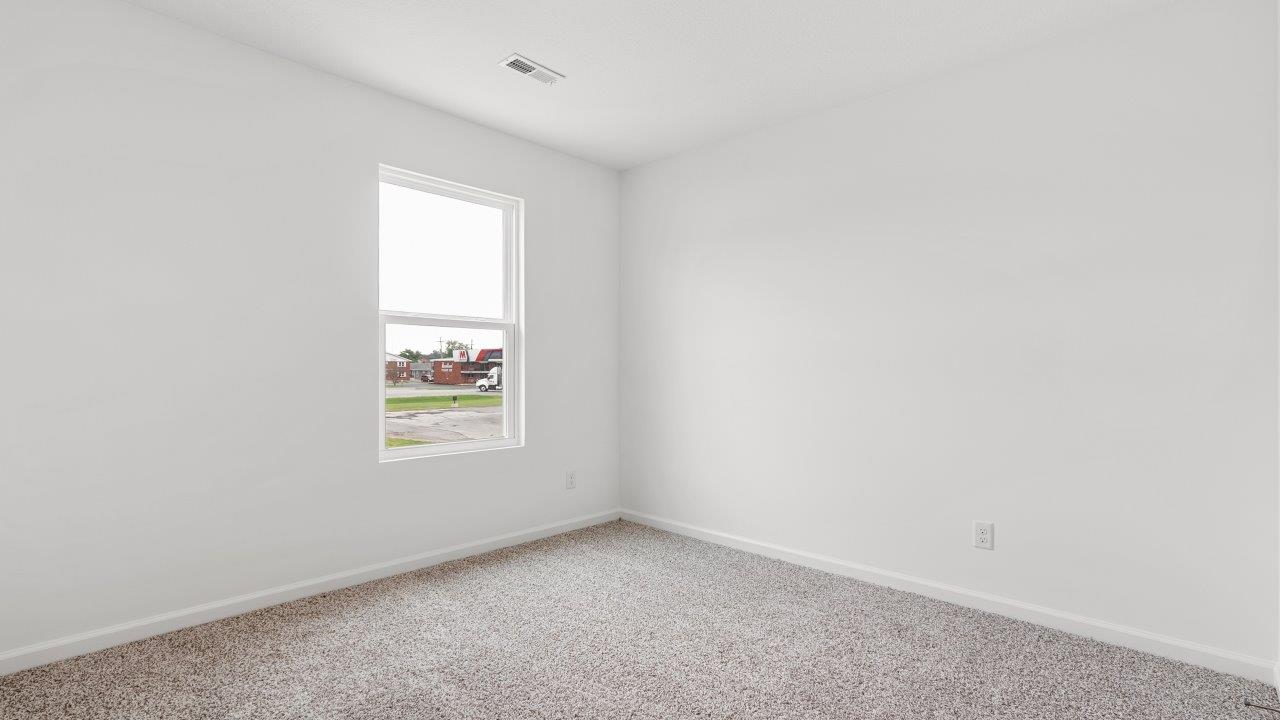 bedroom 2 with carpet flooring and ensuite closet