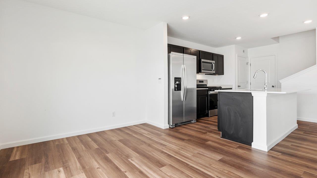casual dining space with luxury vinyl plank flooring with sliding glass door