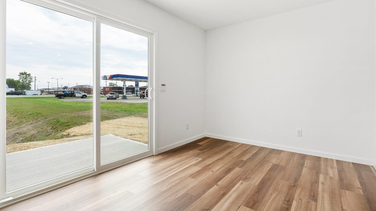 casual dining space with luxury vinyl plank flooring with sliding glass door