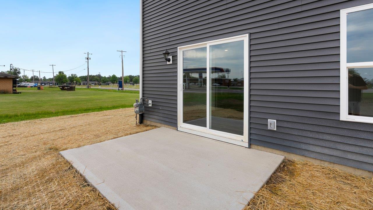 rear exterior with concrete patio