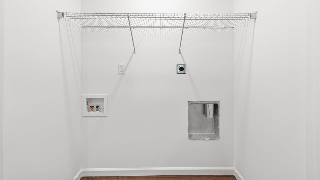 laundry room with lvp flooring and ventilated shelving