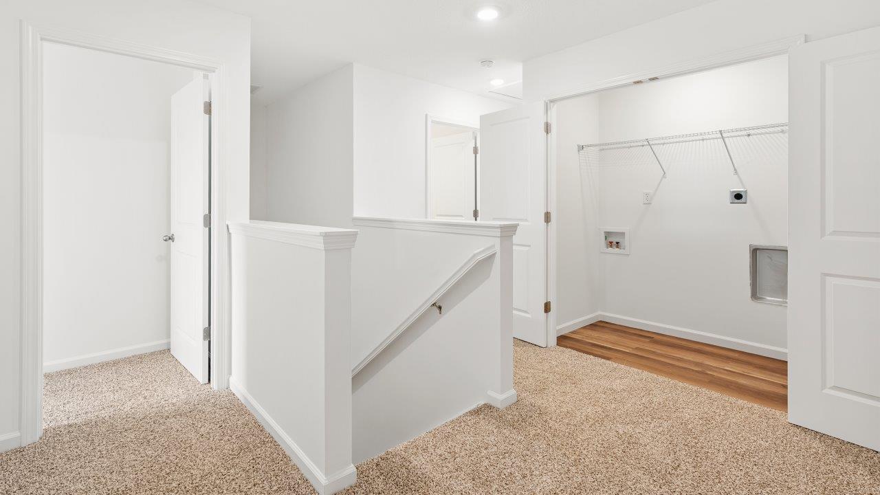 staircase landing with carpet flooring