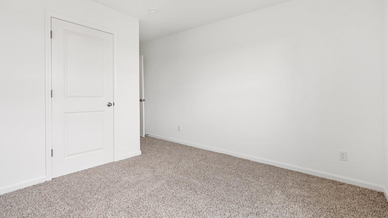 bedroom 2 with carpet flooring and ensuite closet
