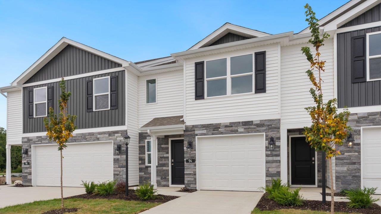 whispering pines pearson exterior with single car garage, sodded yard, and landscaping