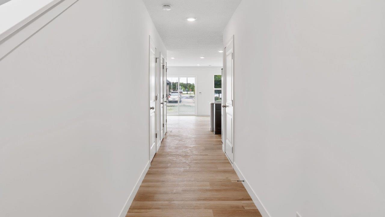 whispering pines pearson - foyer with mohawk lvp flooring leading into open layout living room and kitchen
