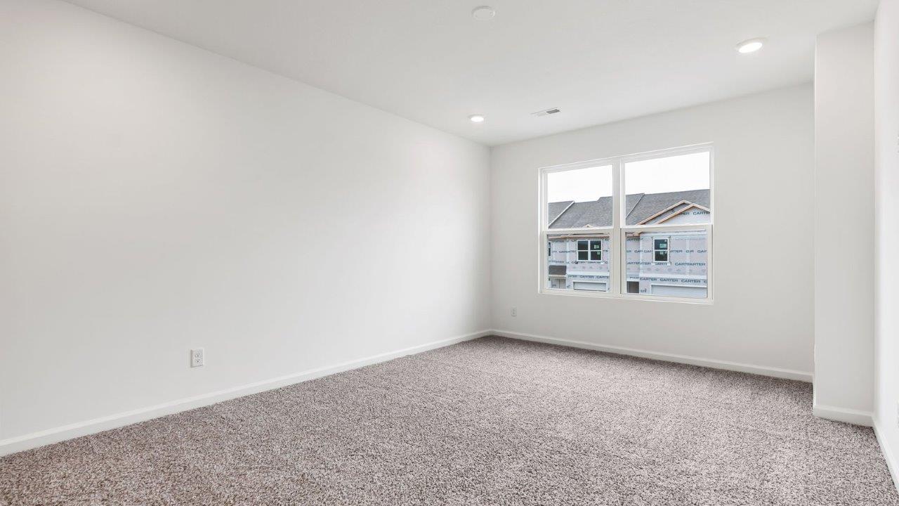 whispering pines pearson primary bedroom with carpet flooring, 2 windows, and ensuite bathroom and walk in closet
