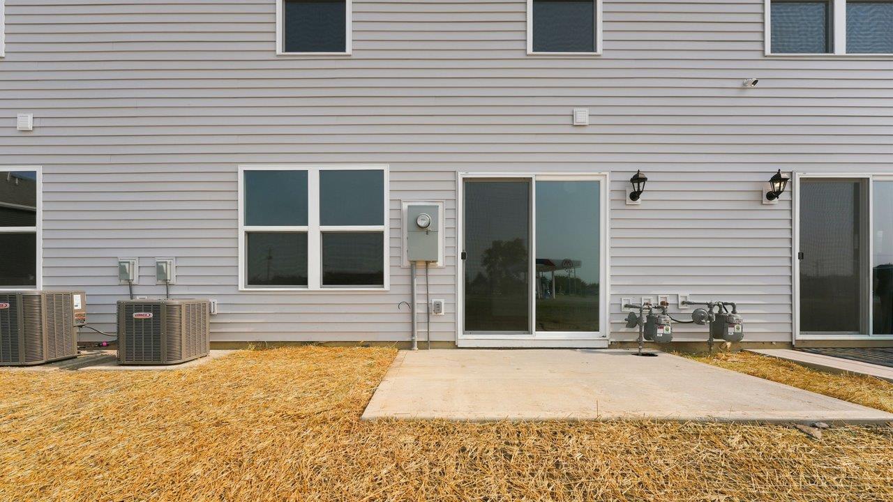 whispering pines pearson townhome exterior with backyard concrete patio
