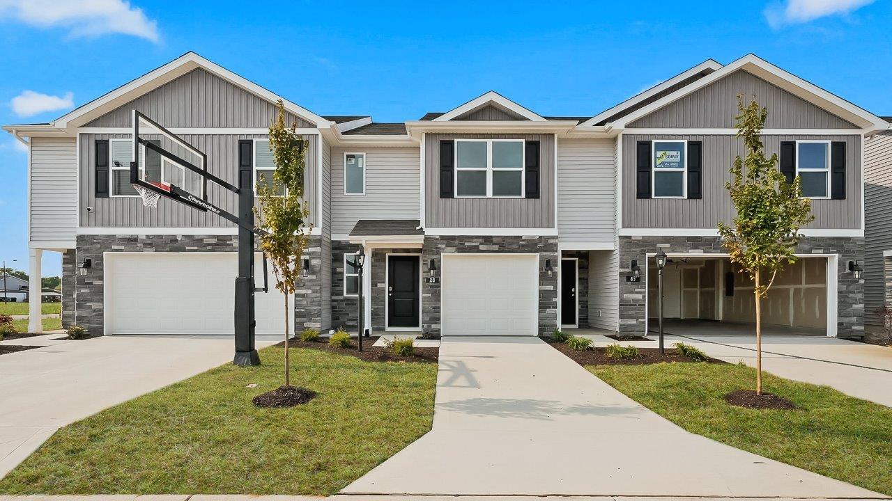 whispering pines pearson plan townhome exterior with sod grass and single garage
