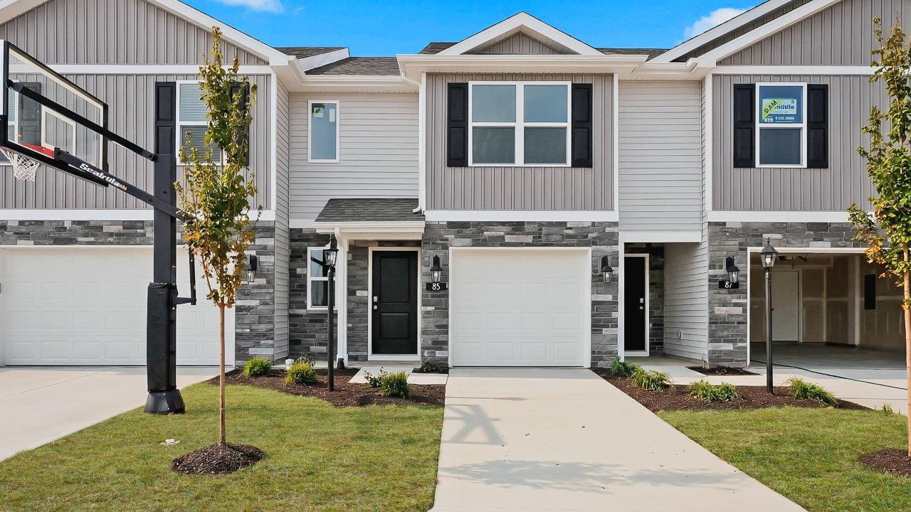 whispering pines pearson plan townhome exterior with sod grass and single garage
