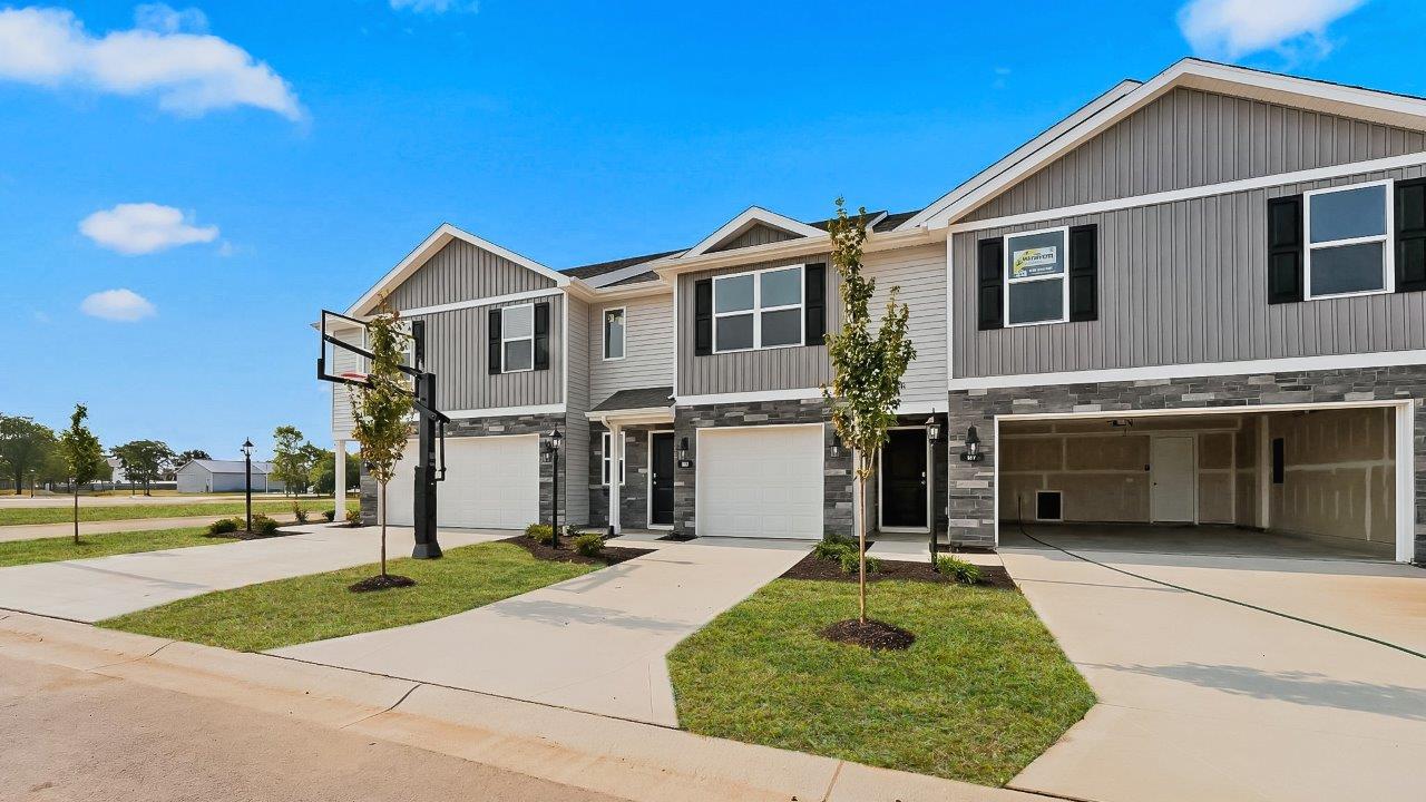 whispering pines pearson plan townhome exterior with sod grass and single garage