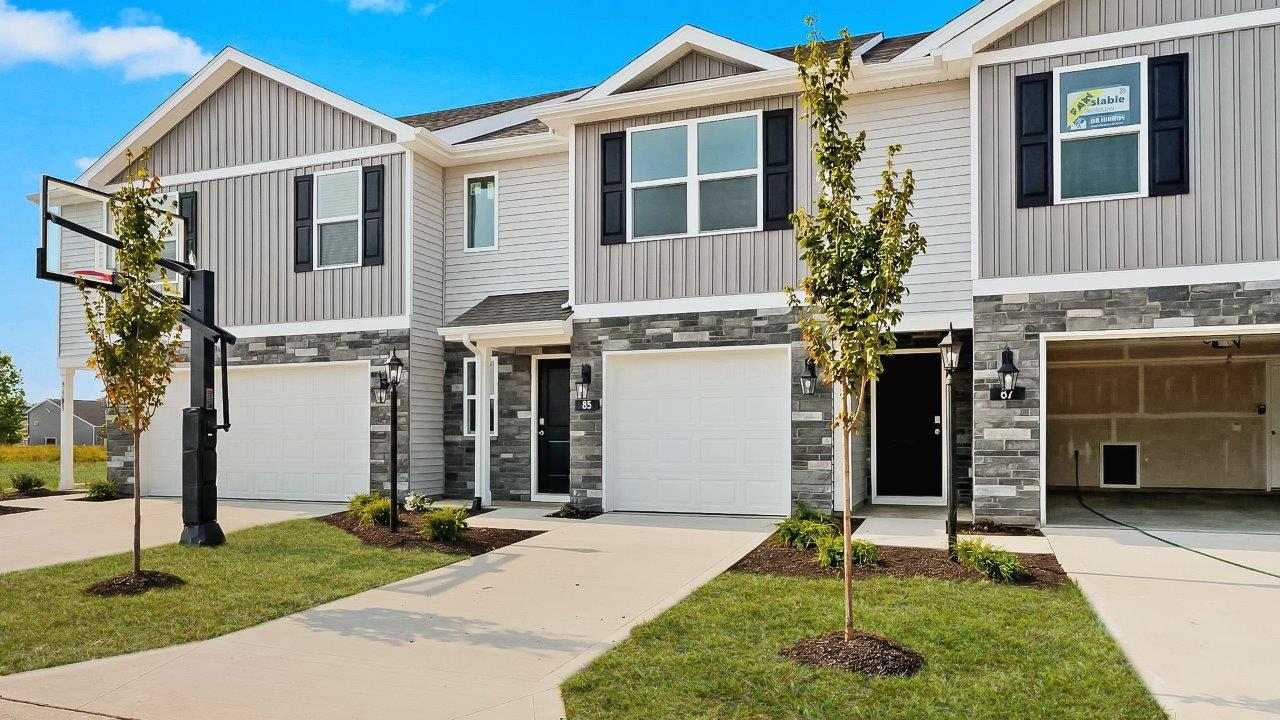 whispering pines pearson plan townhome exterior with sod grass and single garage
