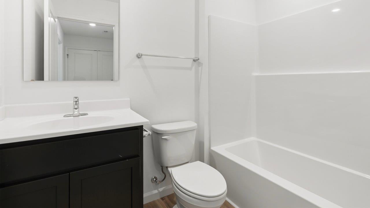full bathroom with single sink vanity and tub shower