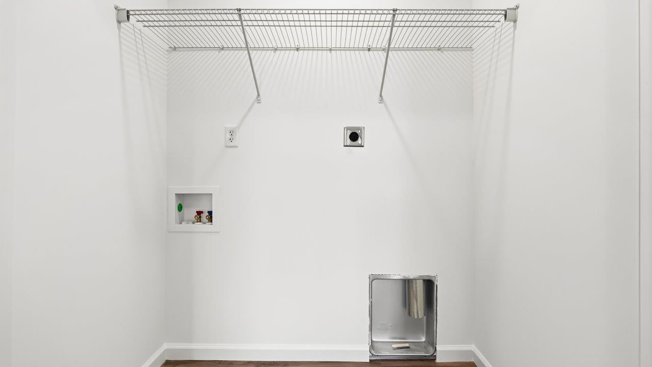 laundry room with lvp flooring and built in ventilated shelf