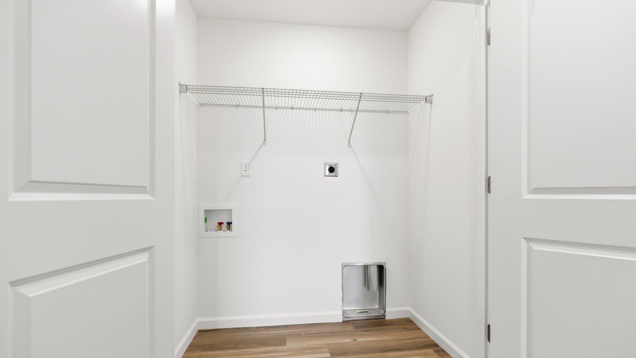 laundry room with lvp flooring and built in ventilated shelf